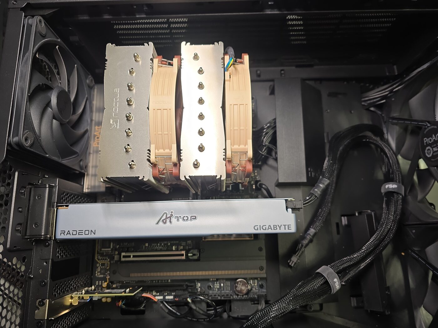Open workstation case showing a Noctua NH-D15 G2 dual-tower air cooler above a Gigabyte Radeon AI TOP graphics card.